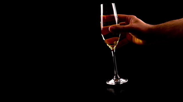 man pouring champagne on black table against black background, not drink and drive, drunk and driving conceptual, saturday night, massacres