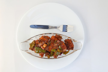 Indian food or Chinese food. Chicken with sweet and sour sauce.