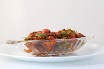 Indian food or Chinese food. Chicken with sweet and sour sauce.