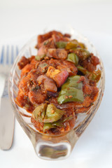 Indian food or Chinese food. Chicken with sweet and sour sauce.