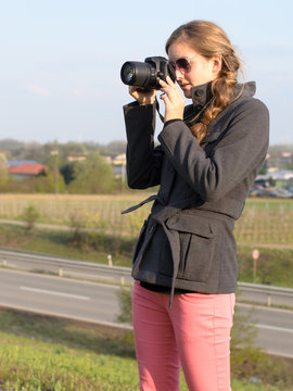 Young smiling woman taking photos :)
