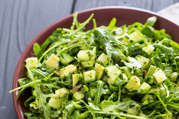 Beautiful Paleo Green Salad with Cucumber and Avocado on a Dark Grey Wooden Background, Horizontal, Close-up