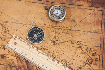 Old style brass compass on antique map