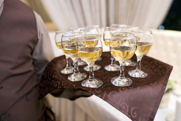 waiter with a tray welcomes visitors