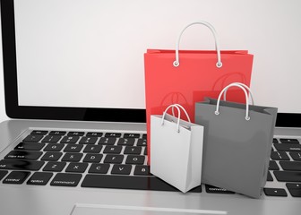 laptop and  shopping pags on white background