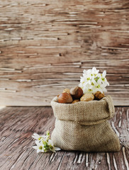 canvas bag with nuts on a wooden table