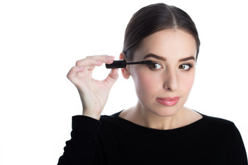 Obraz premium Beautiful young woman applied mascara, studio beauty portrait