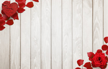 Love background scene with free space for text. Petals, rose, gift heart on wooden background.