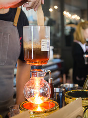 close up of barista with siphon coffee maker