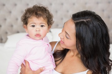 Happy brunette looking at her baby