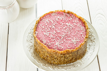 Raw Vegan Paleo Diet Berry Cheesecake Gluten-Free with Dates and Cashews on a Light White Wooden Background, Horizontal
