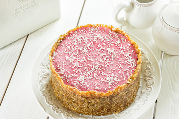Raw Vegan Paleo Diet Berry Cheesecake Gluten-Free with Dates and Cashews on a Light White Wooden Background, Horizontal