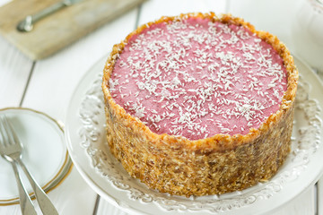 Raw Vegan Paleo Diet Berry Cheesecake Gluten-Free with Dates and Cashews on a Light White Wooden Background, Horizontal