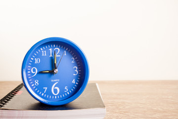 blue alarm clock and notebook
