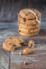 Tasty cookies and glass of milk on rustic wooden background