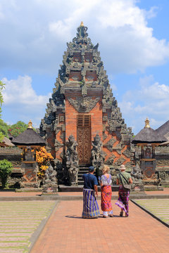 Guide and tourists in ancient temple