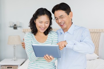 Happy couple using tablet