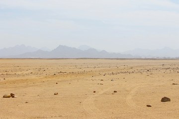 Fototapeta na wymiar Egyptian Desert, Sand And Sky, Mountains In Background