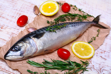 ingredients for baking scomber fillets, include raw mackerel, lemon, garlic, rosemary