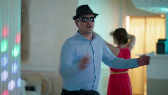 man dancing with a hat and sunglasses