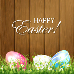 Wooden Easter background with three colorful eggs