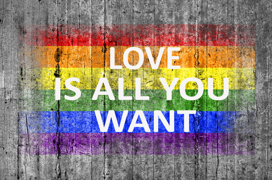 Love is all you want and LGBT flag painted on background texture