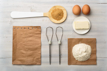 Top view of food ingredients on a white wooden background with copy space for recipe