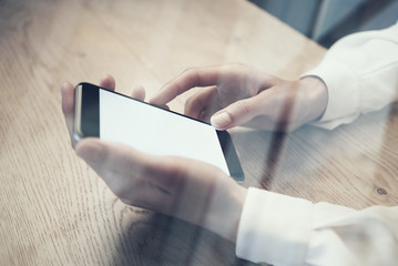 Close up of generic design smart phone holding in female hands for texting message.