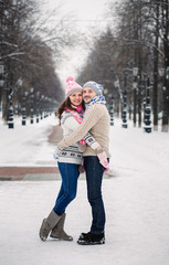 Portrait of young smiling couple in scarf and sweaters in winter