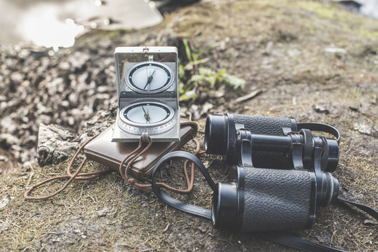 The old type of compass and binoculars in nature