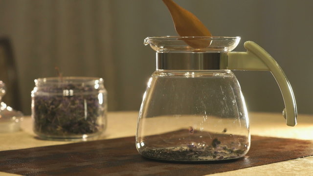 Brewing kipany tea in a glass teapot