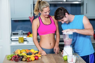 Healthy couple preparing a smoothie