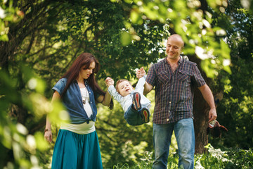 Young Parents Playing with Their Son