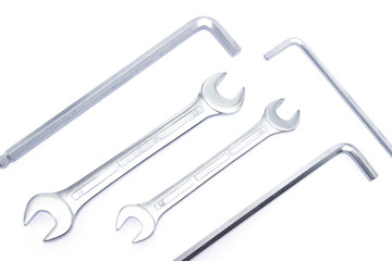 Different sized chrome wrenches isolated on white, top view