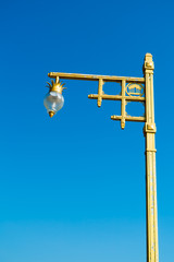 Beautiful gold lamppost with lantern pineapple design on public roadside in Prachuap Khiri Khan province, Thailand