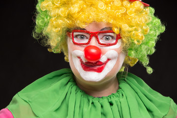 Funny curly clown in shiny glasses with good cheerful emotions