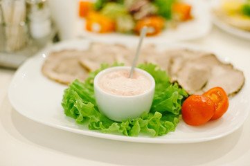 Plate of sausage and smoked meat or ham