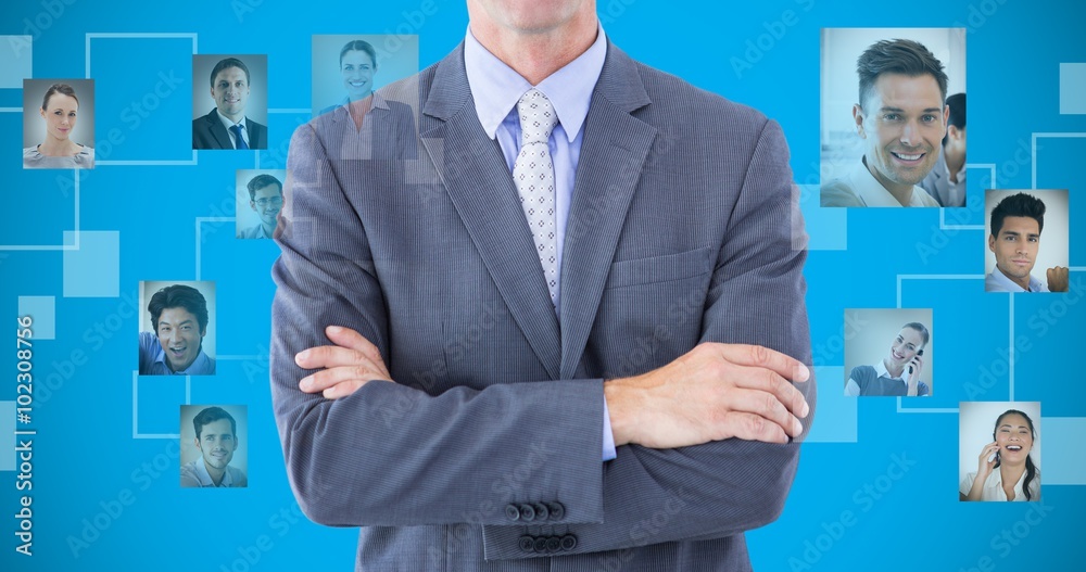 Wall mural Composite image of businessman standing with arms crossed