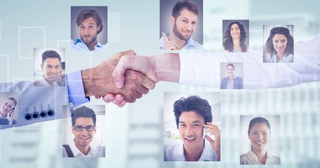 Obraz na płótnie Canvas Composite image of business people shaking hands