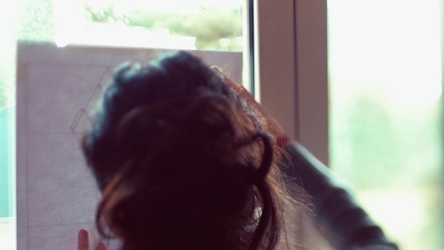 Teen girl tracing lines on plan
