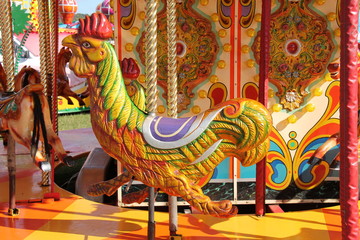 A Rooster Chicken Seat on a Fun Fair Carousel Ride.