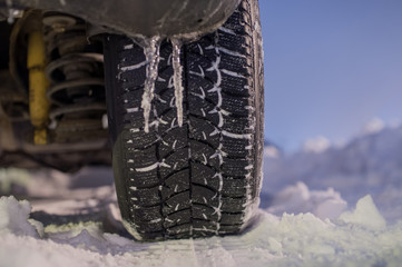 Winter tyre on the road with snow