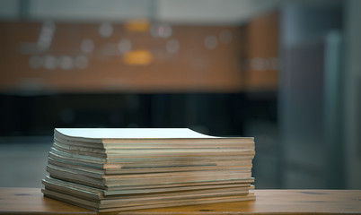 stack of old magazines on wooden table