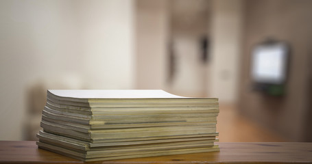 stack of old magazines on wooden table