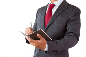 Businessman write planning on notepad with pen isolated on white background