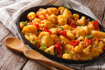 Indian vegetarian Gobi Aloo close-up on a plate. Horizontal