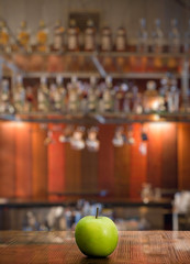 Fototapeta na wymiar apple on table in a night club