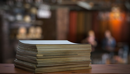 stack of old magazines on wooden table