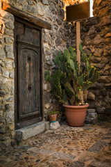 Fototapeta na wymiar old wooden door in the narrow streets of Cefalu