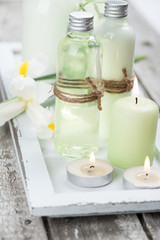Bath products, candles, wooden background